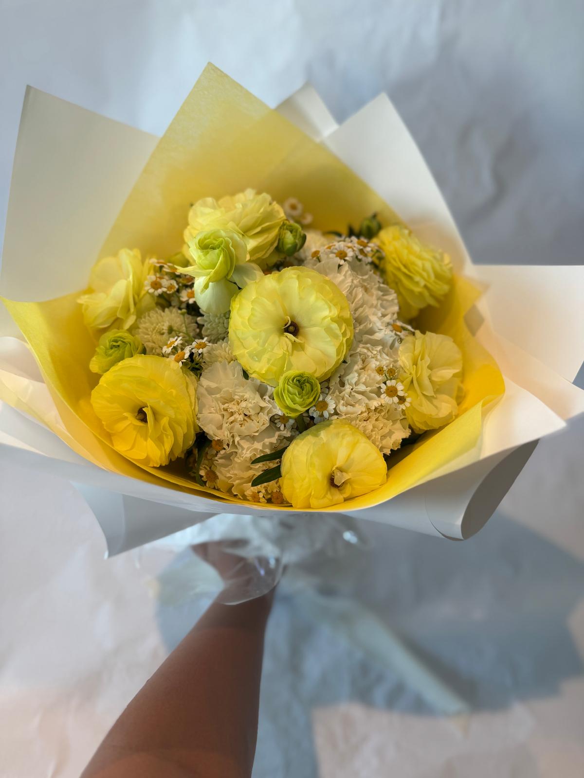 Gender-neutral baby shower bouquet in soft cream, white, and pale yellow tones with a delicate and serene appearance.