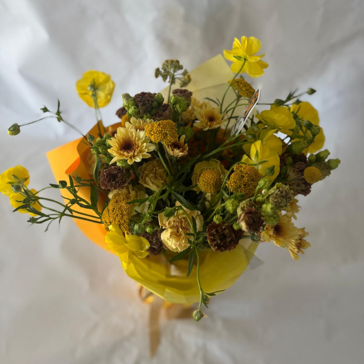 Signature floral bouquet inspired by the Padres, featuring rich brown, gold, and cream blooms. Wrapped in Korean paper with a silk ribbon and matching team sticker.