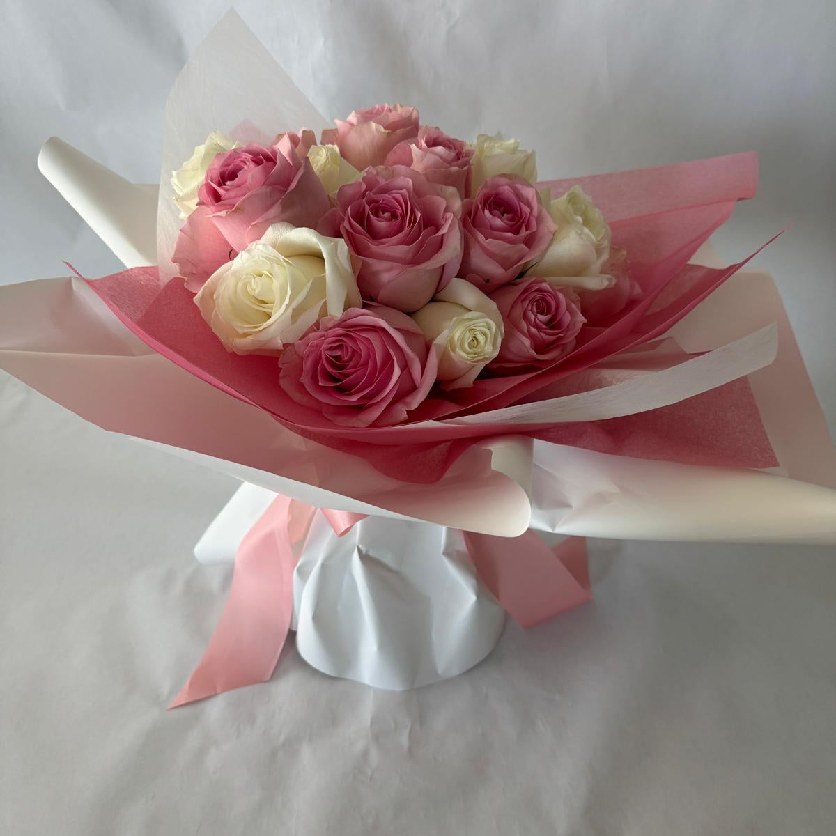 A bouquet of mixed pink and white roses in your chosen size.