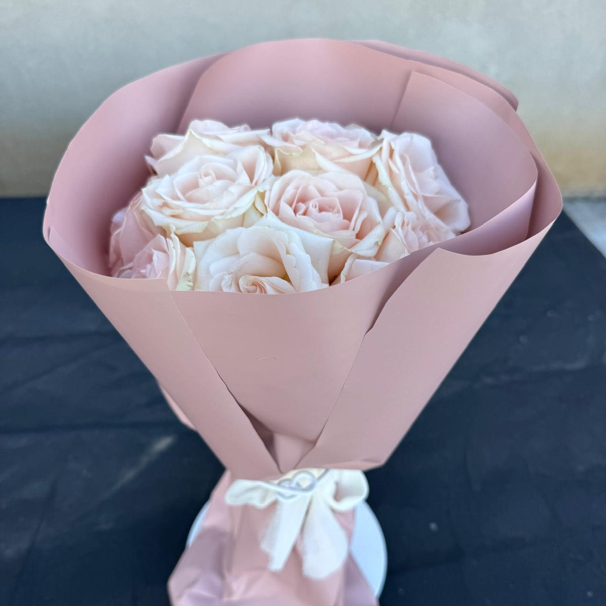 Blush rose bouquet wrapped in soft pink paper by Nai Pascoal Bouquets