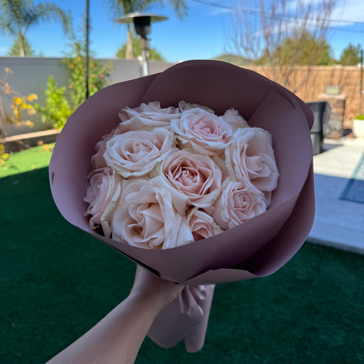 Blush rose bouquet wrapped in soft pink paper by Nai Pascoal Bouquets
