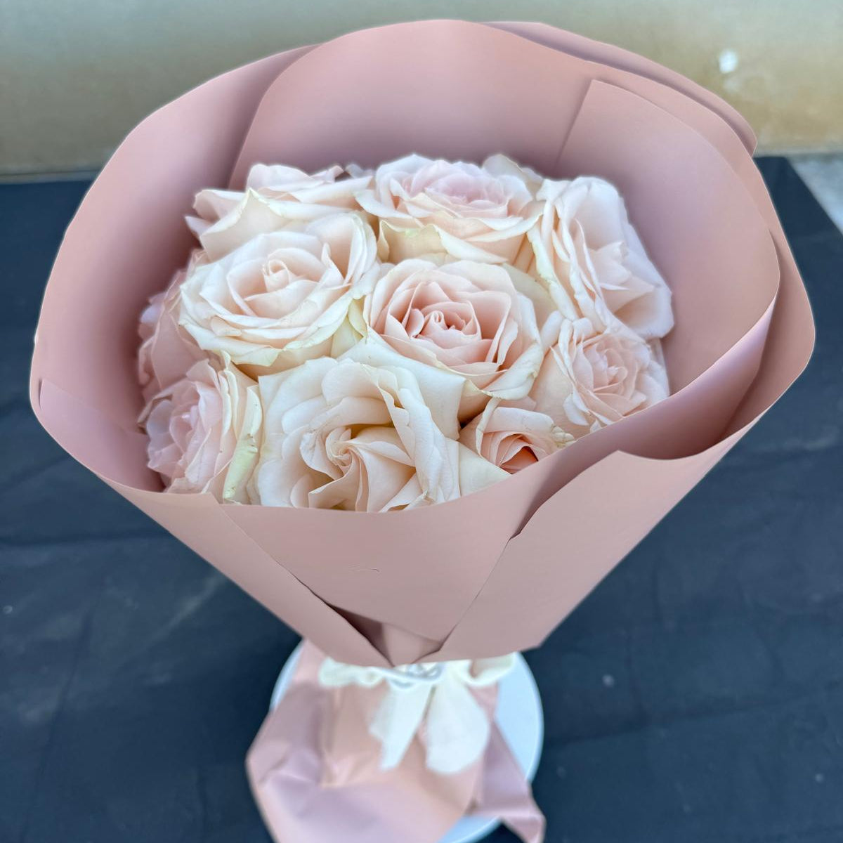 Blush rose bouquet wrapped in soft pink paper by Nai Pascoal Bouquets