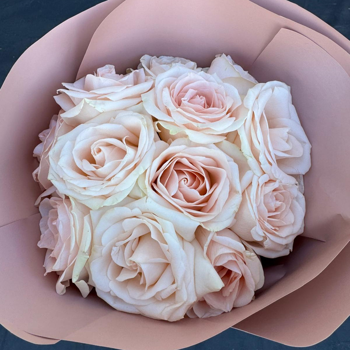Blush rose bouquet wrapped in soft pink paper by Nai Pascoal Bouquets