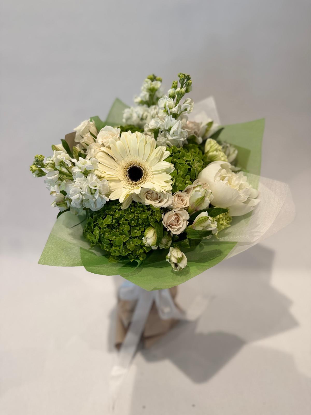 White and green bouquet with soft wrapping and a light, crisp aesthetic.