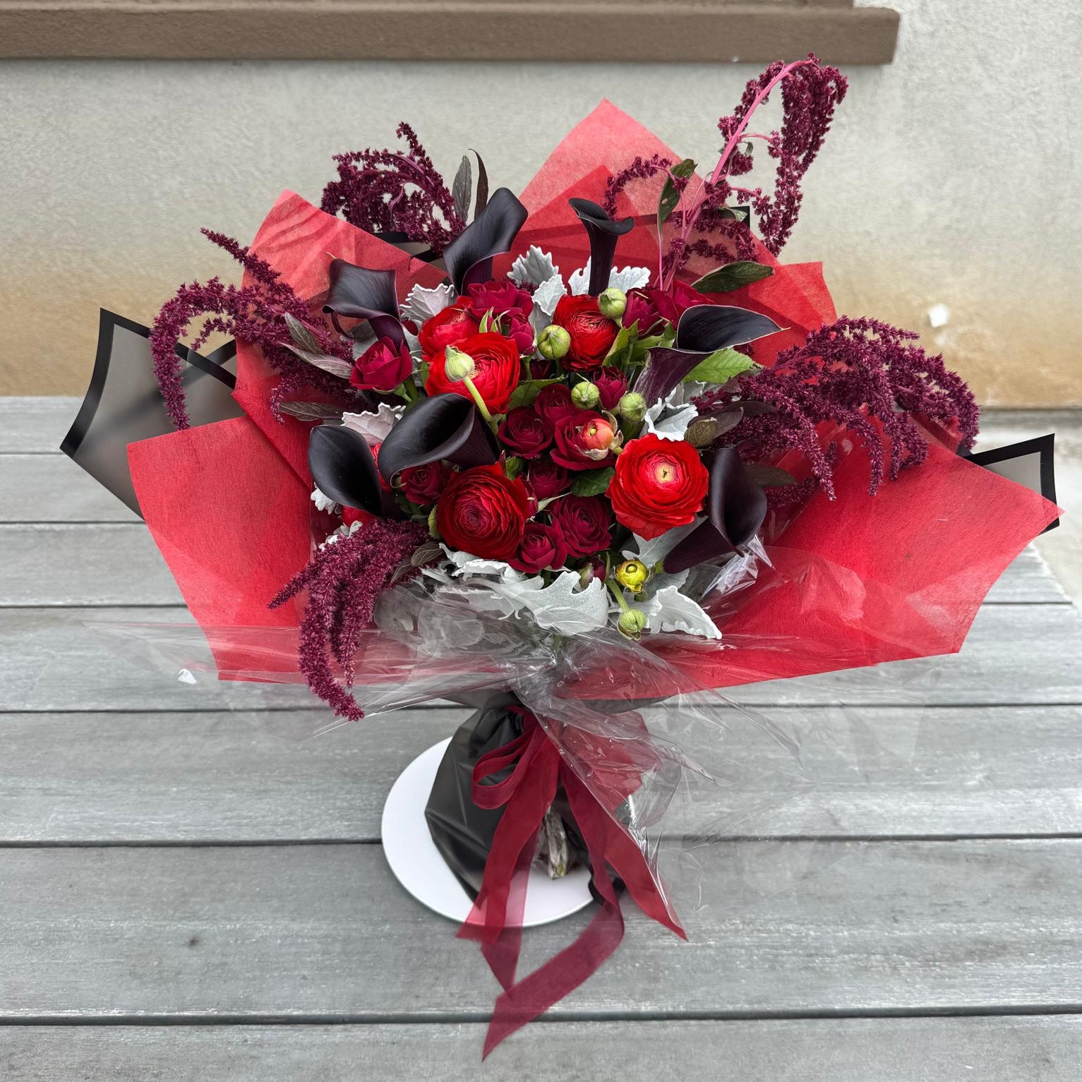 Vampire’s Kiss Bouquet with red roses and black calla lilies – vampire-inspired flowers by Nai Pascoal Bouquets.