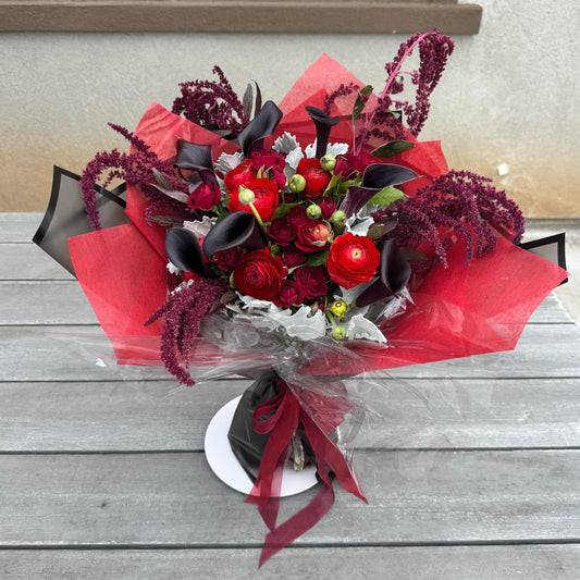 Vampire’s Kiss Bouquet with red roses and black calla lilies – vampire-inspired flowers by Nai Pascoal Bouquets.